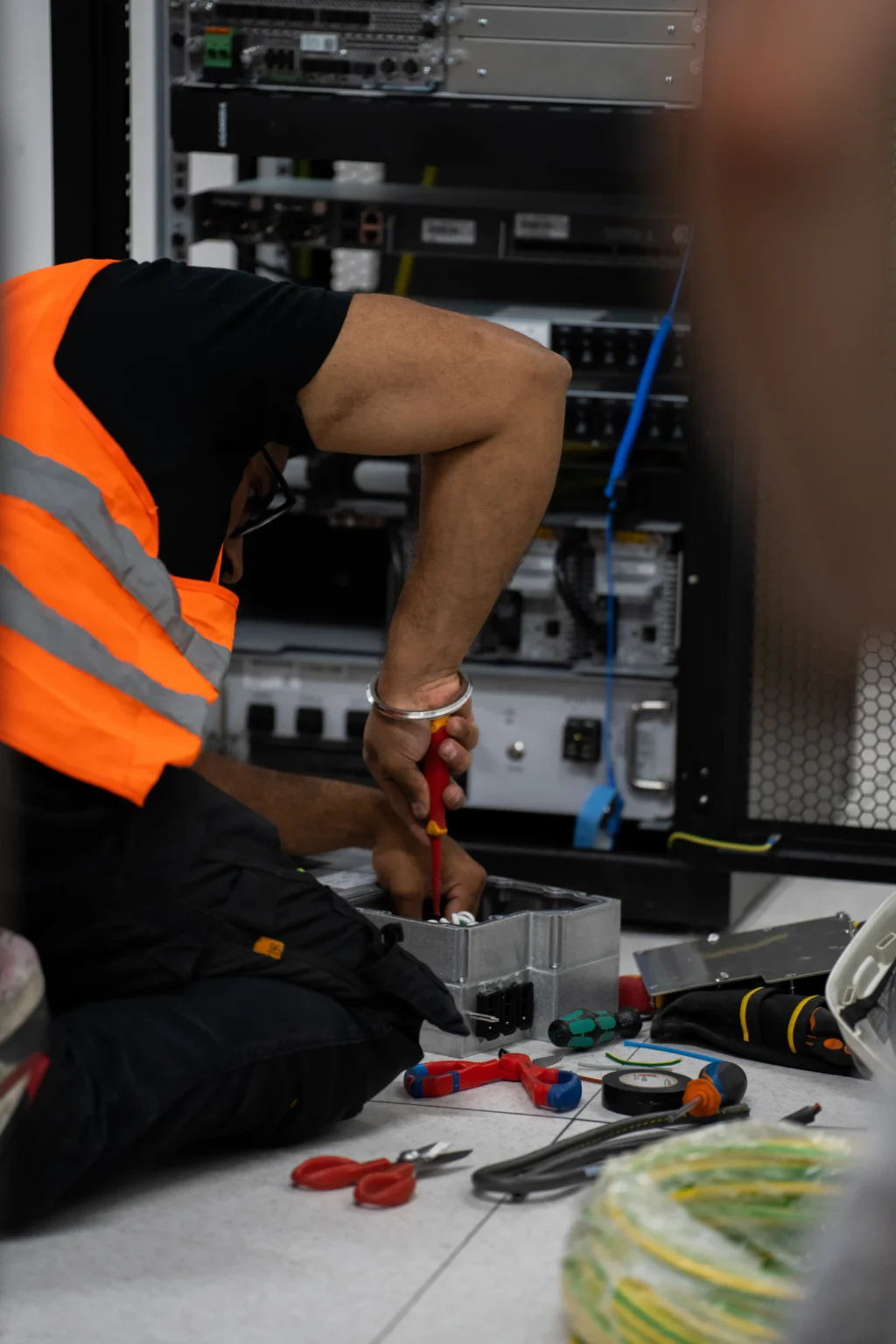 Silverback technician working on network equipment in a rack